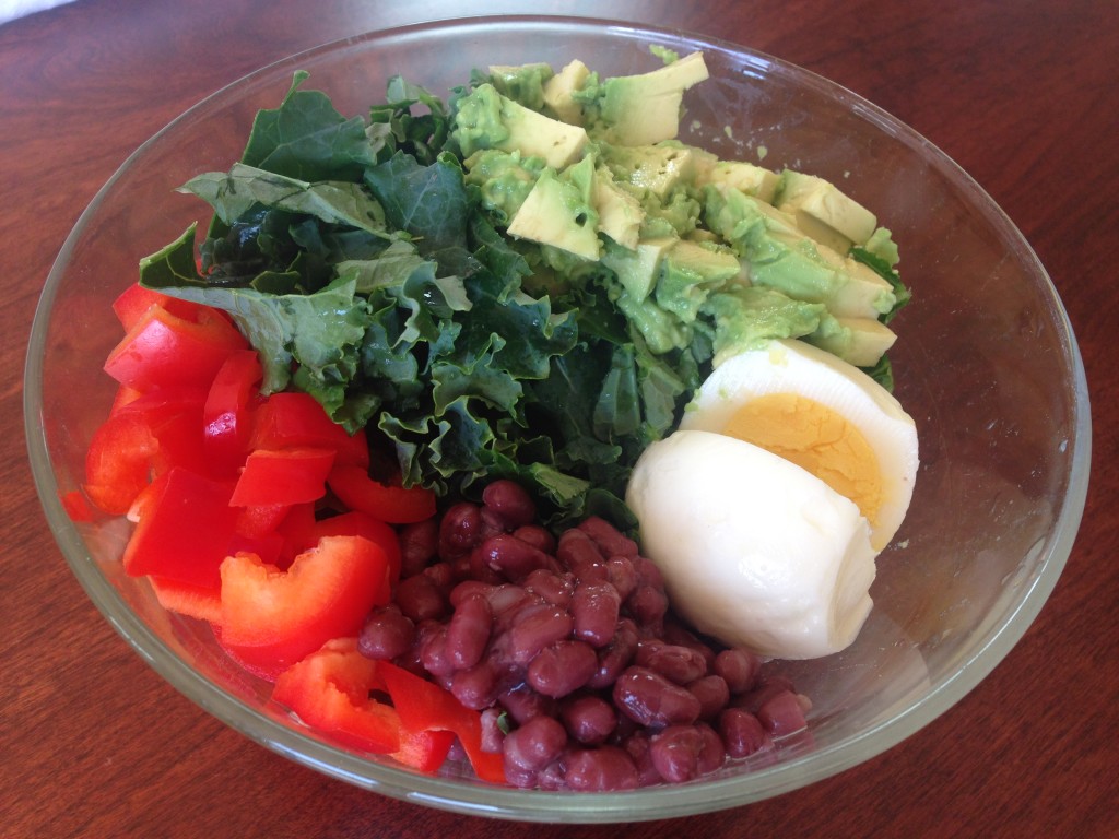 kale salad with bell pepper, beans, hard boiled egg, and avocado